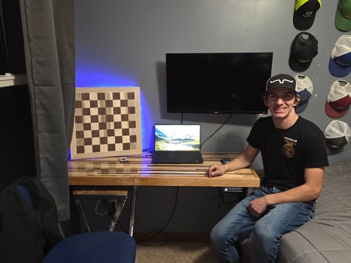 Logan Klatt with his custom-made Designer Table and checkerboard